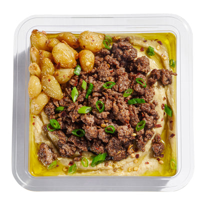 Next Level Taste Chummus Basar close up with confit garlic and ground beef, kosher, white background