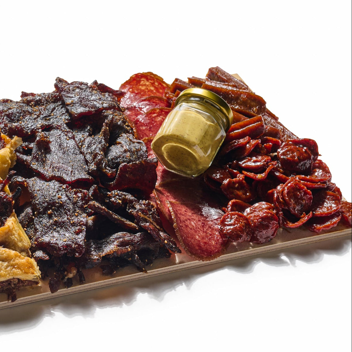 Next Level Taste Crave Board with beef jerky and cured kosher meats, white background