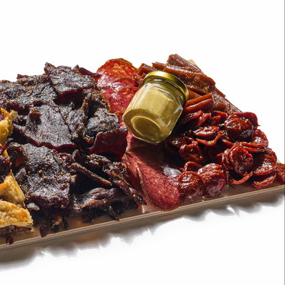 Next Level Taste Crave Board with beef jerky and cured kosher meats, white background
